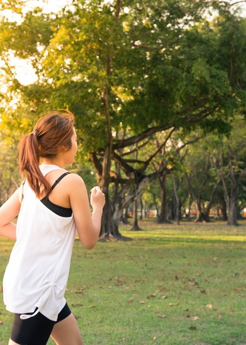 Atividade Física Canva - Young Woman Running in Wood, Training and Exercising for Trail R (1).jpg